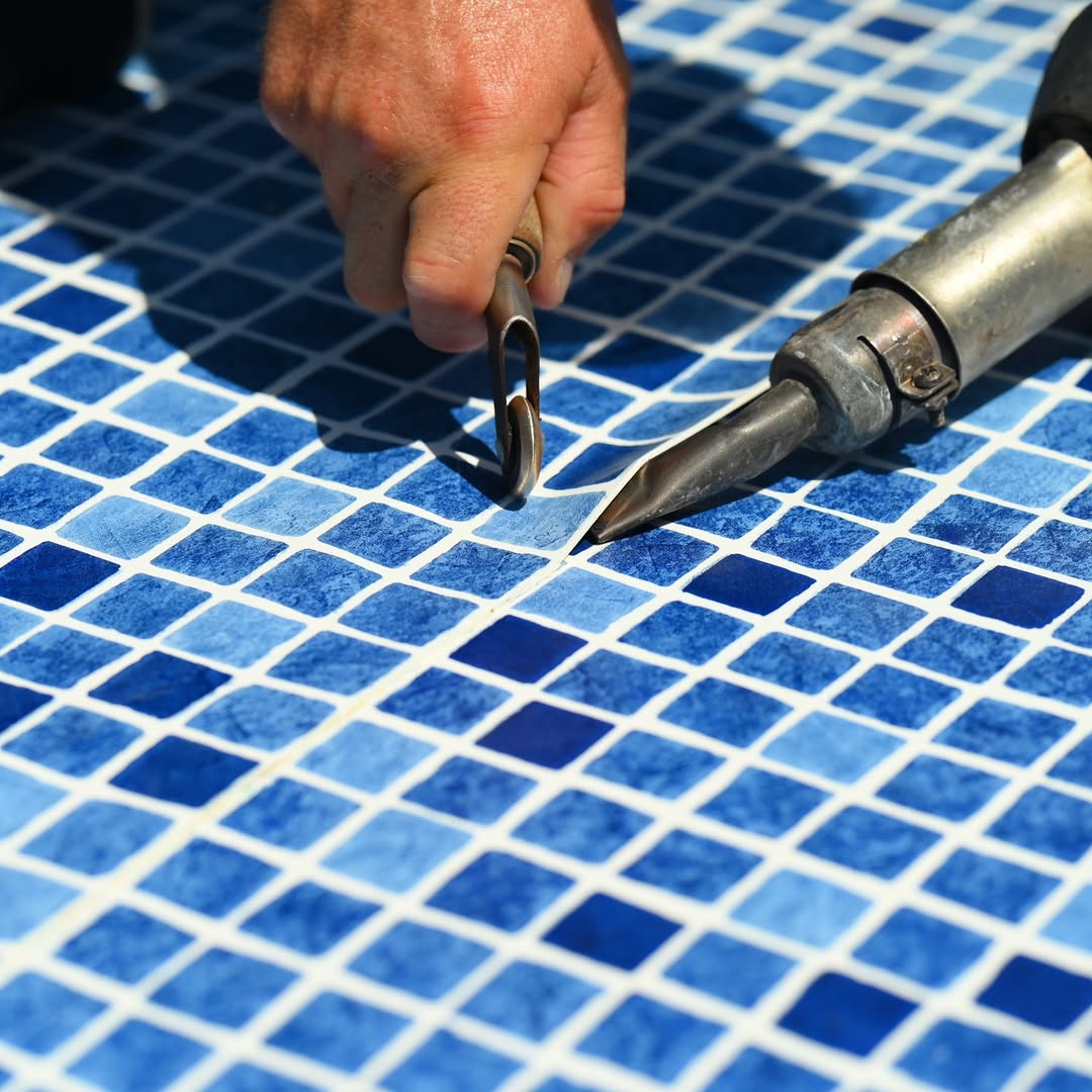 Hot-air welding the Dreamz PVC Membrane seam on a mosaic-print pool liner