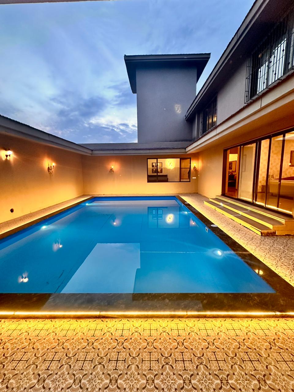 Pool contractor — Indoor courtyard swimming pool with mood lighting by Dreamz Pools